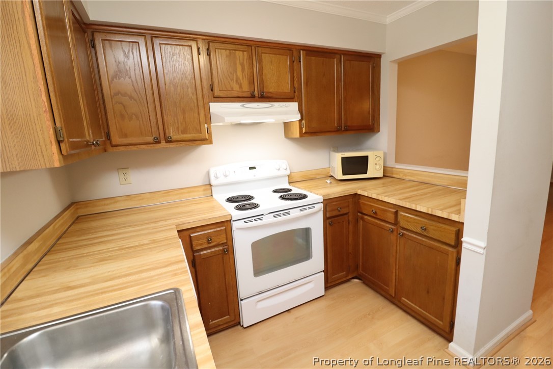 7424 Penny Hill Lane Raleigh, NC 27615 - Photo 6 of 30 a kitchen with a stove and a sink