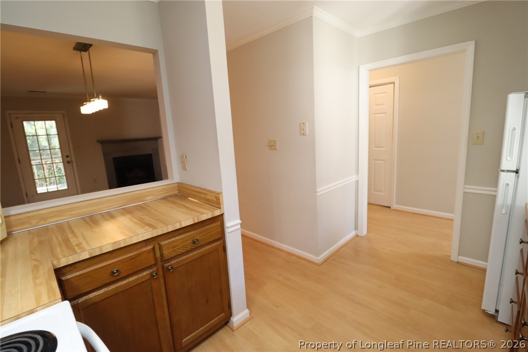 7424 Penny Hill Lane Raleigh, NC 27615 - Photo 7 of 30 a view of a kitchen with furniture and a fireplace