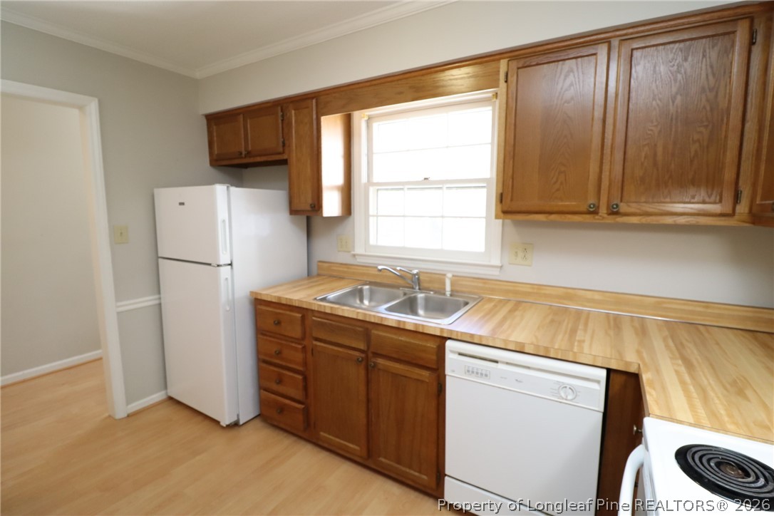 7424 Penny Hill Lane Raleigh, NC 27615 - Photo 8 of 30 a kitchen with a refrigerator sink and cabinets