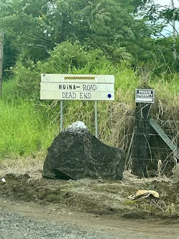 a sign that is sitting on a rock