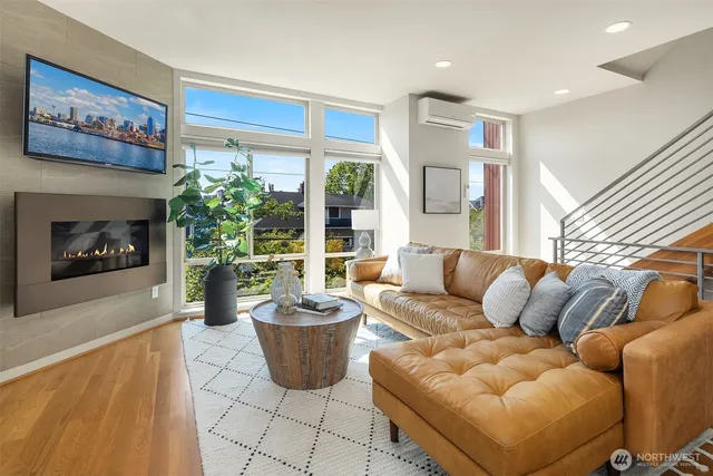 a living room with furniture a fireplace and a potted plant