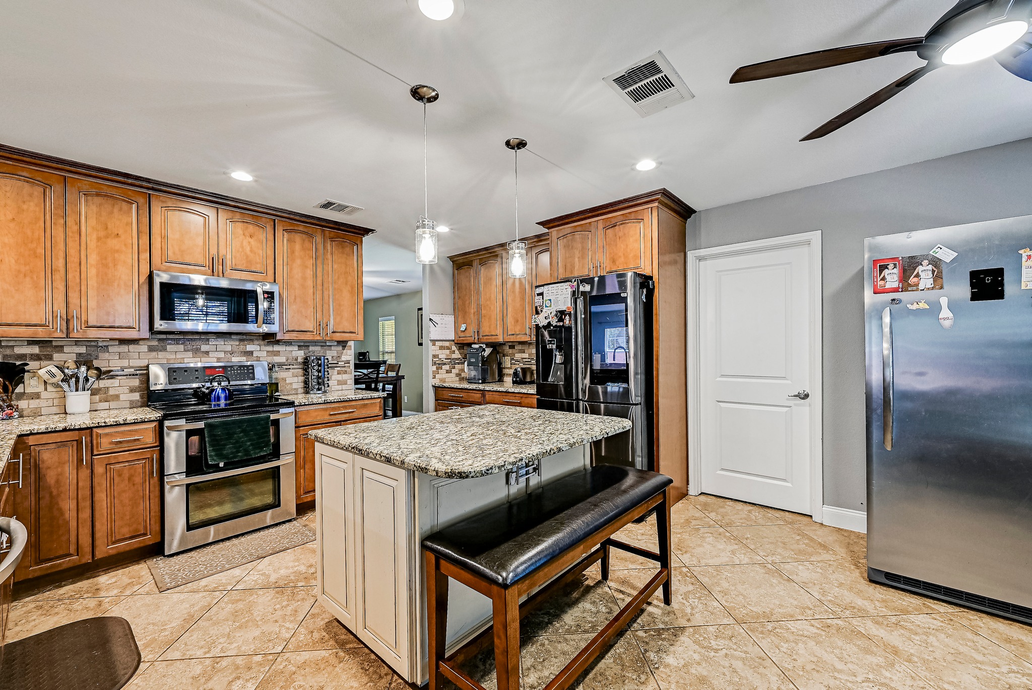 104 North Sumac Lane Georgetown, TX 78633 - Photo 14 of 40 Granite counters and rich wood cabinetry create a well-appointed kitchen perfect for culinary endeavors.