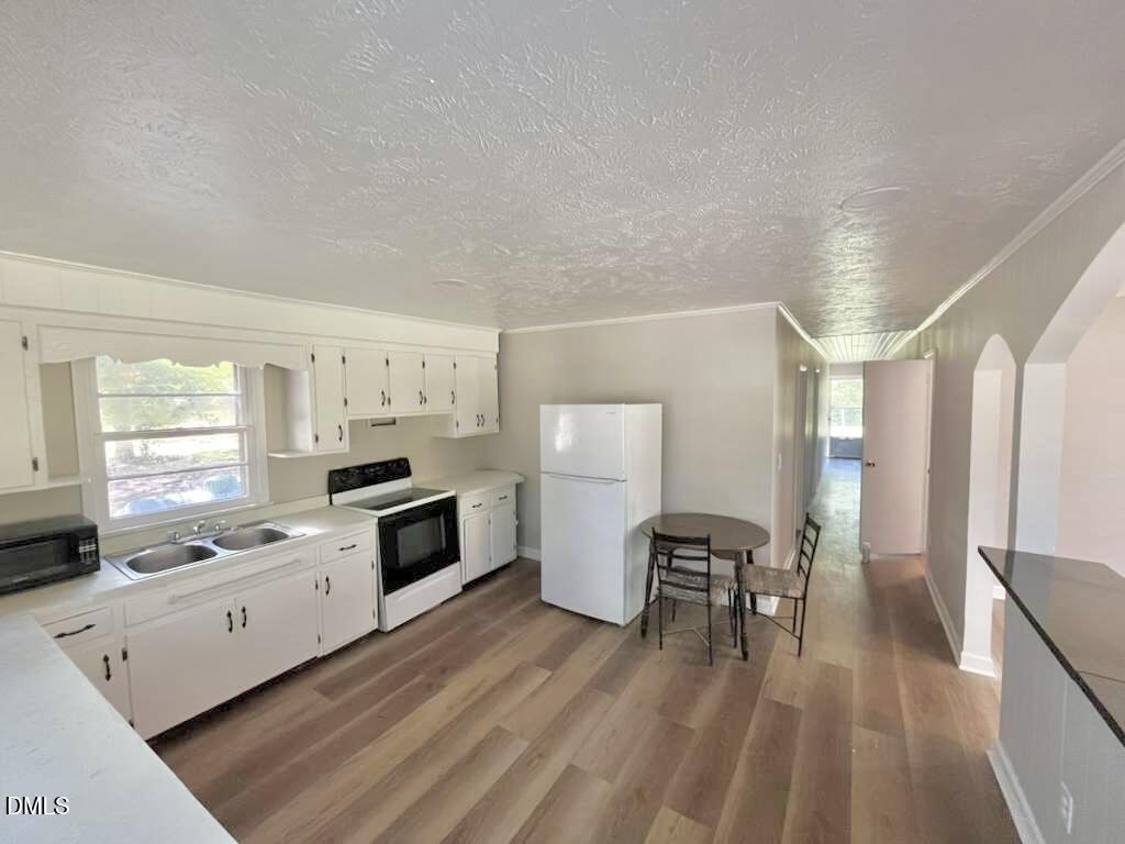185 Summerhill Road Turkey, NC 28393 - Photo 6 of 18 a kitchen with granite countertop white cabinets and white appliances