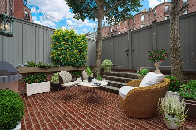 a view of a patio with couches and potted plants