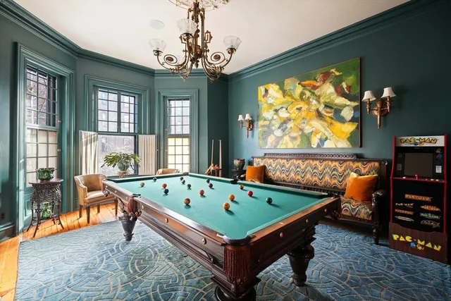 a room with furniture and pool table