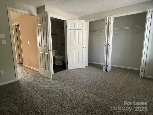 an empty room with closet and wooden door