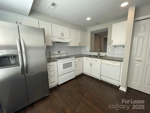 a kitchen with stainless steel appliances cabinets a sink and a counter top space