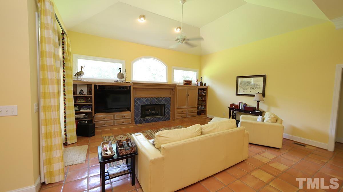 5817 Stone Spring Road Raleigh, NC 27613 - Photo 8 of 28 a living room with furniture and a fireplace