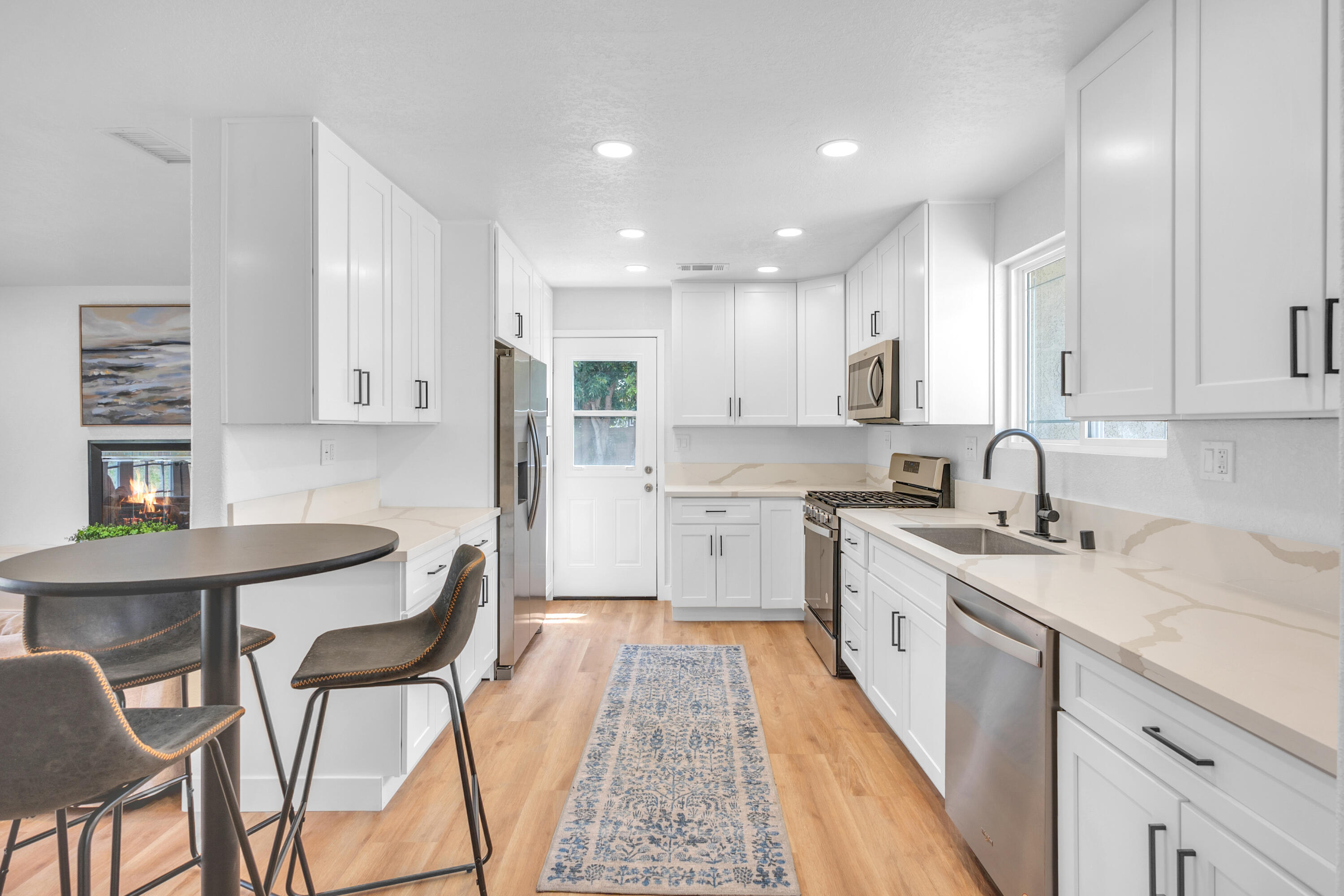 1621 Arcane Street Simi Valley, CA 93065 - Photo 11 of 63 a large kitchen with stainless steel appliances granite countertop a table chairs sink and cabinets