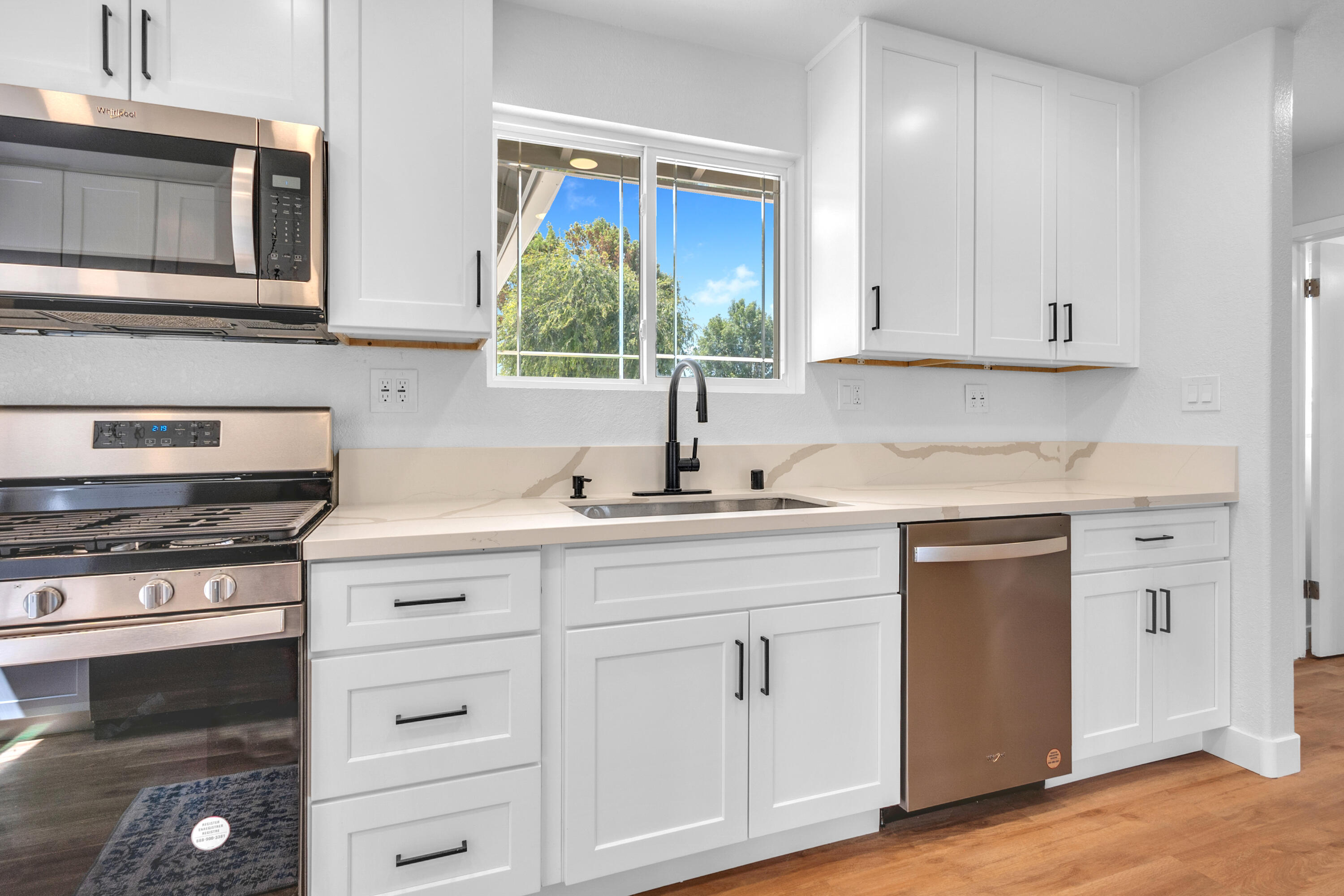 1621 Arcane Street Simi Valley, CA 93065 - Photo 14 of 63 a kitchen with white cabinets and sink