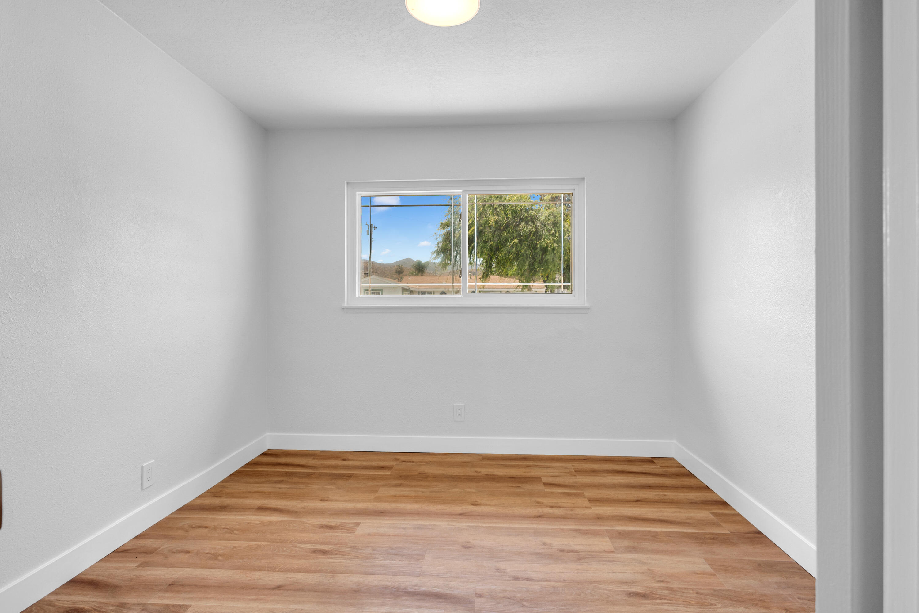 1621 Arcane Street Simi Valley, CA 93065 - Photo 27 of 63 a view of an empty room with wooden floor and a window