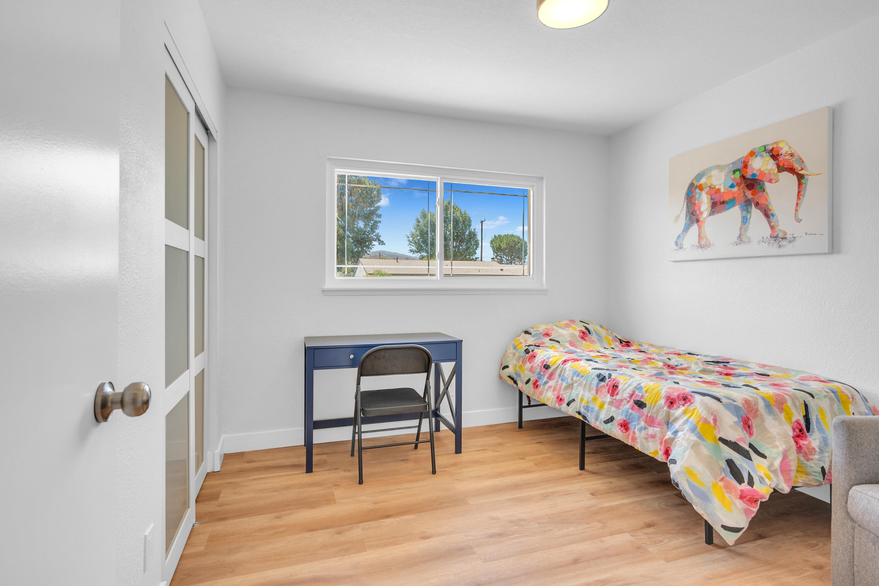 1621 Arcane Street Simi Valley, CA 93065 - Photo 28 of 63 a bedroom with a bed and a chair with wooden floor