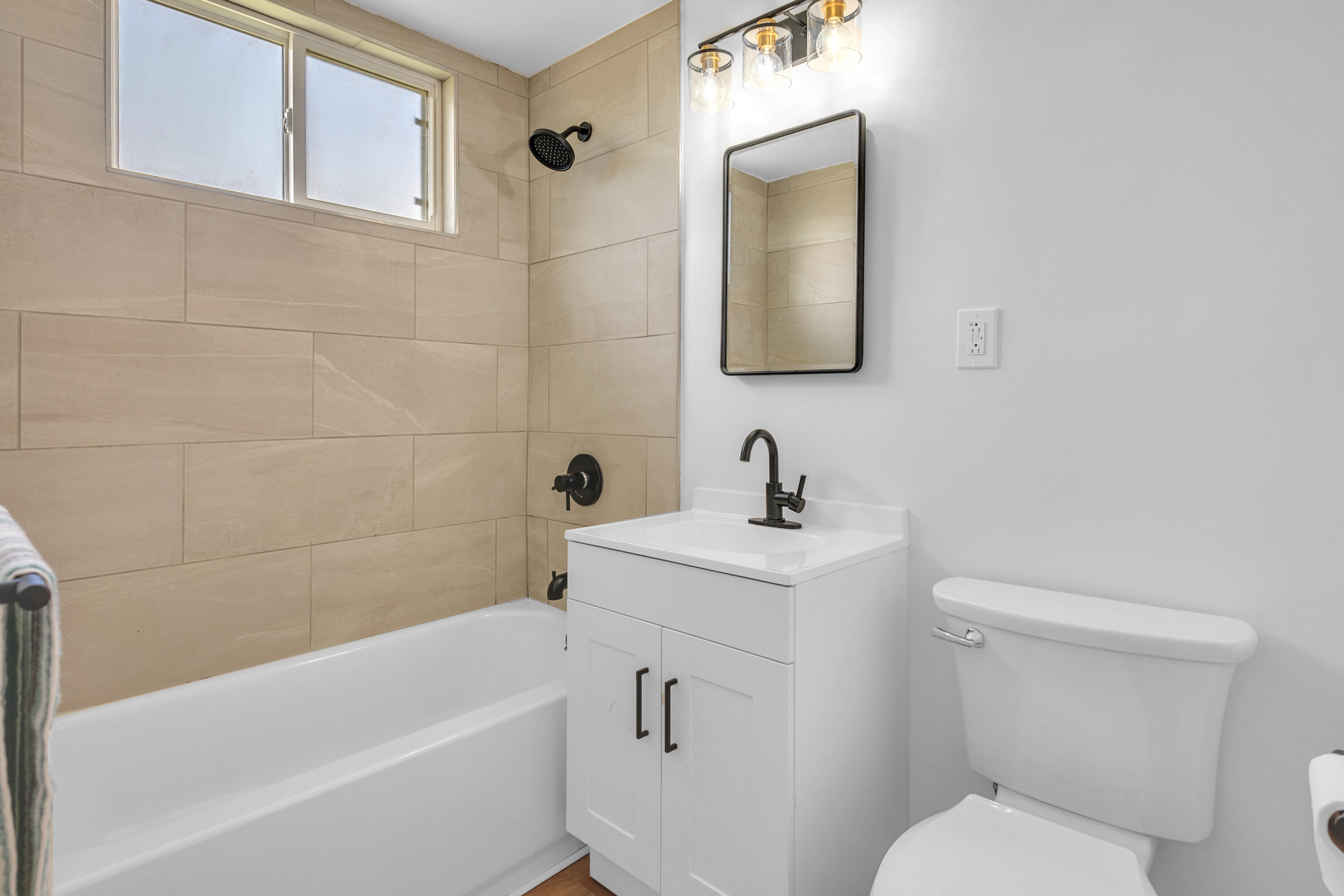 1621 Arcane Street Simi Valley, CA 93065 - Photo 40 of 63 a bathroom with a toilet a sink a mirror and bathtub