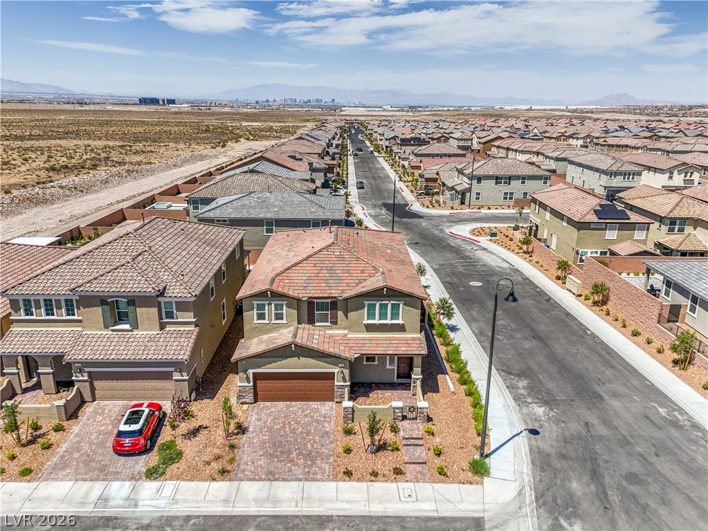3782 Alla Rocca Avenue Henderson, NV 89044 - Photo 43 of 55 An aerial view captures a quiet suburban street with modern homes under a clear sky.