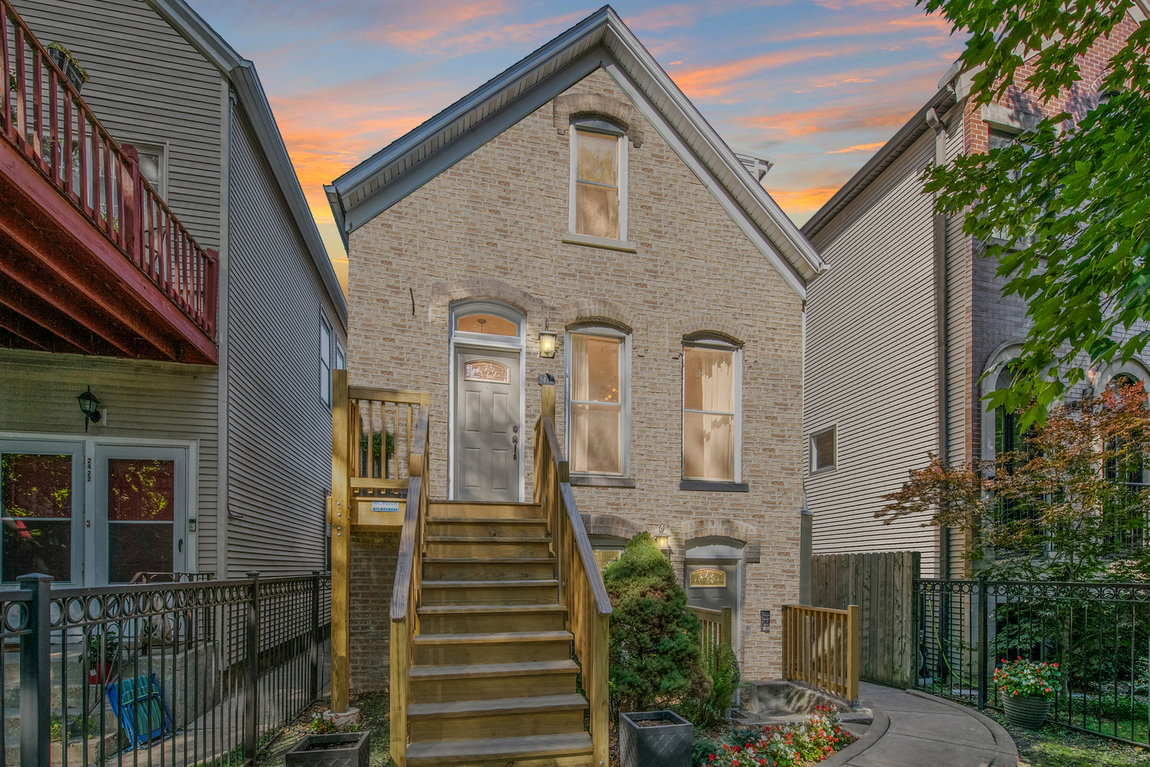 a front view of a house with a garden