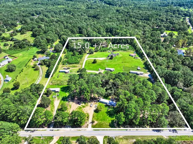 an aerial view of a houses with a yard