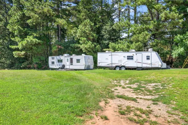 an aerial view of a house with a yard