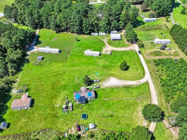 a backyard of a house with lots of green space and tub
