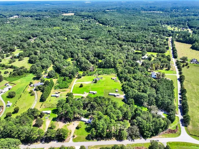 a backyard of a house with trees and plants