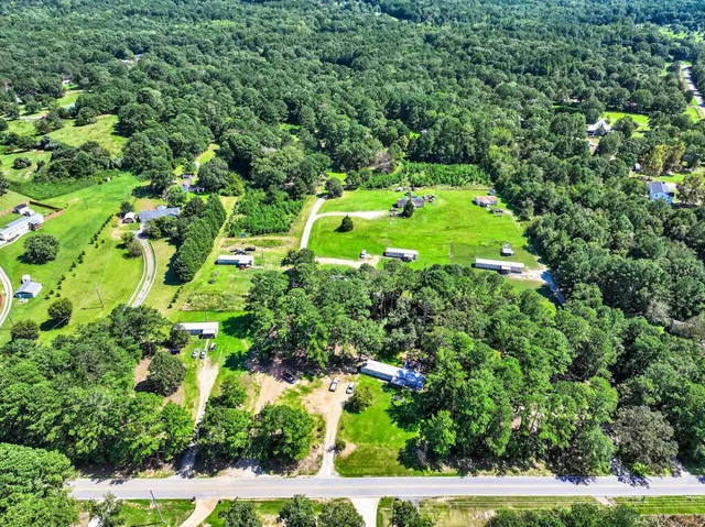 an aerial view of a house with a yard