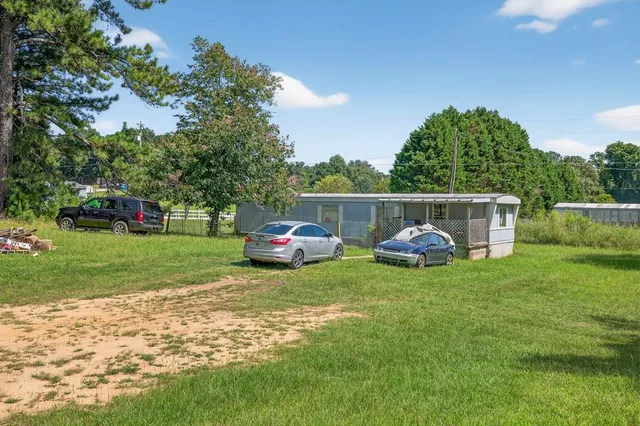 a view of a house with a yard and sitting area