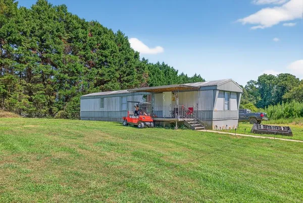 a view of a back yard of the house with green space