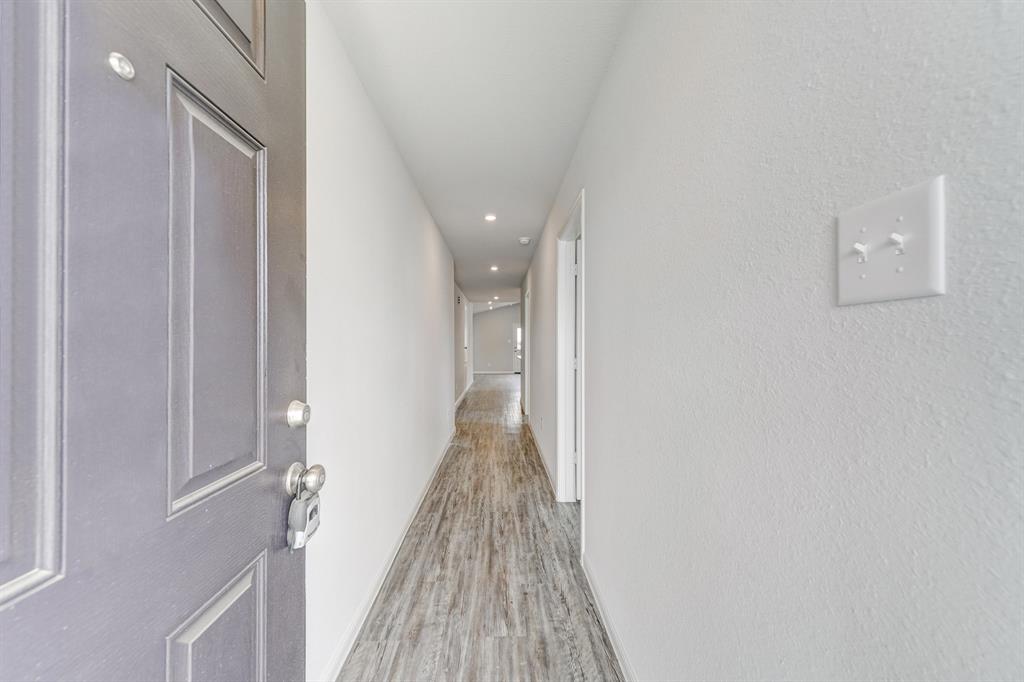 309 Victory Drive Mabank, TX 75147 - Photo 19 of 37 a view of a hallway with wooden floor