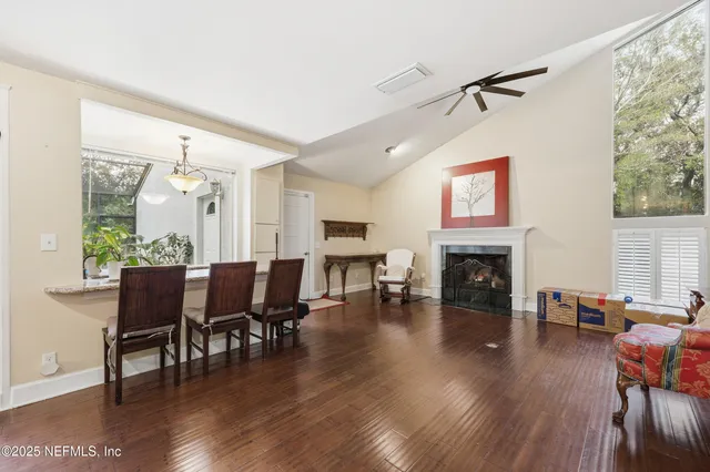an aerial view of residential houses with outdoor space and trees