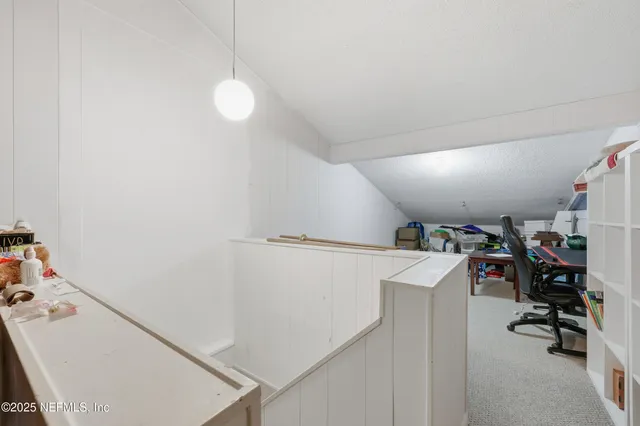 a view of swimming pool with outdoor seating and trees in the background