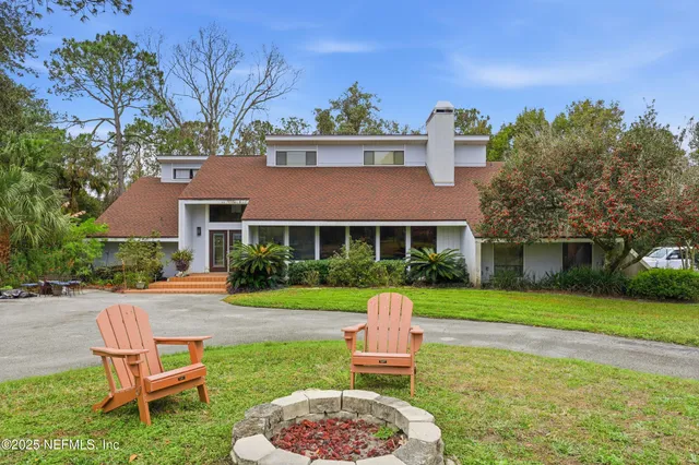 a view of a park with a bench and trees