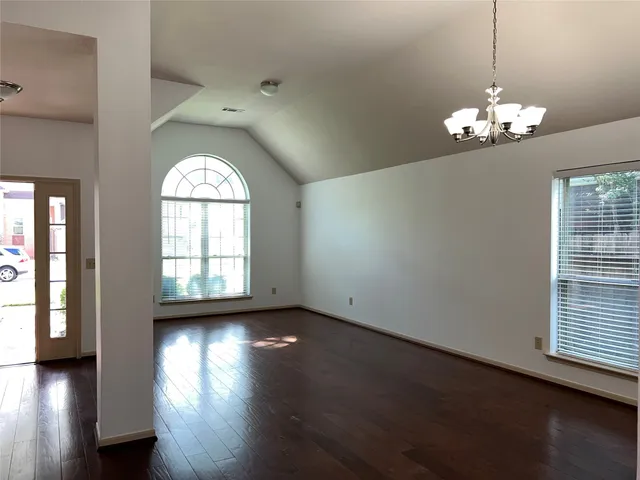 a view of a room with wooden floor and windows
