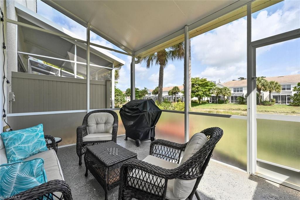 981 Hampton Circle, Unit 119 Naples, FL 34105 - Photo 22 of 30 a outdoor living space with furniture and a garden