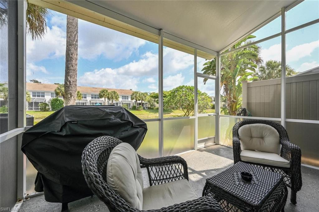 981 Hampton Circle, Unit 119 Naples, FL 34105 - Photo 23 of 30 a balcony with table and chairs