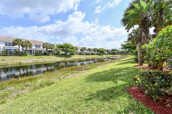 a view of a lake with houses in the back