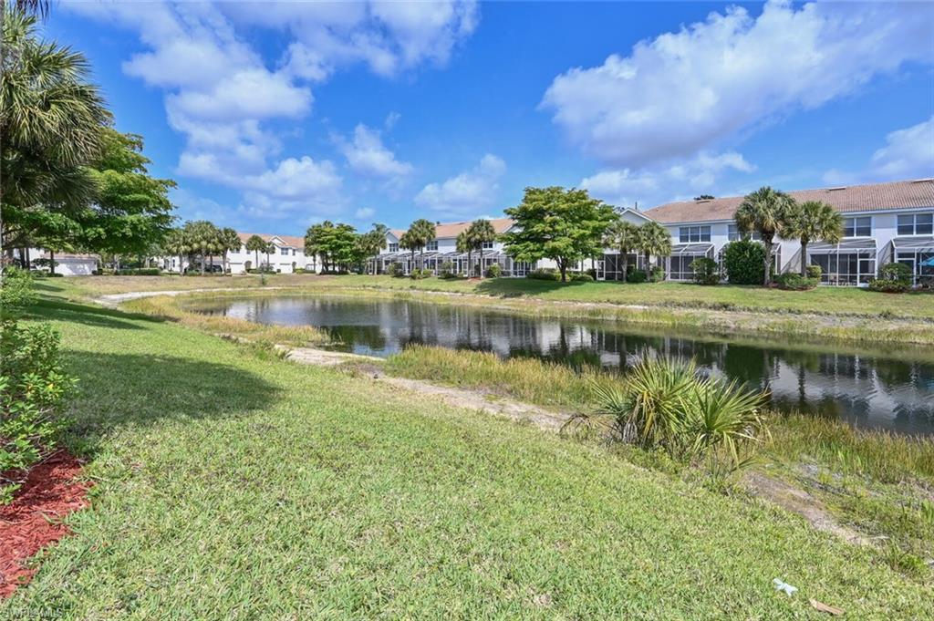 981 Hampton Circle, Unit 119 Naples, FL 34105 - Photo 25 of 30 a view of a lake with houses in the background