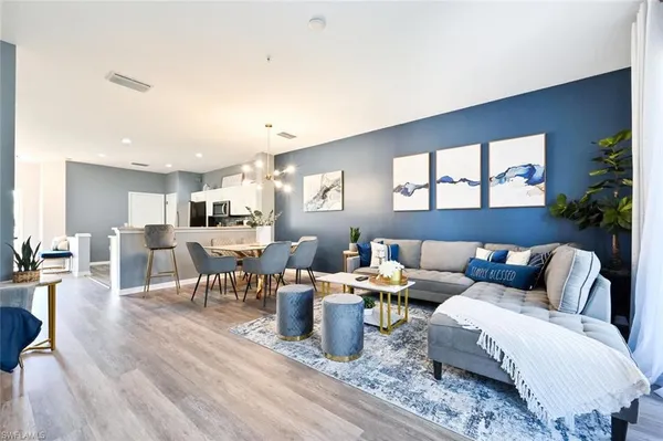 a living room with furniture and wooden floor