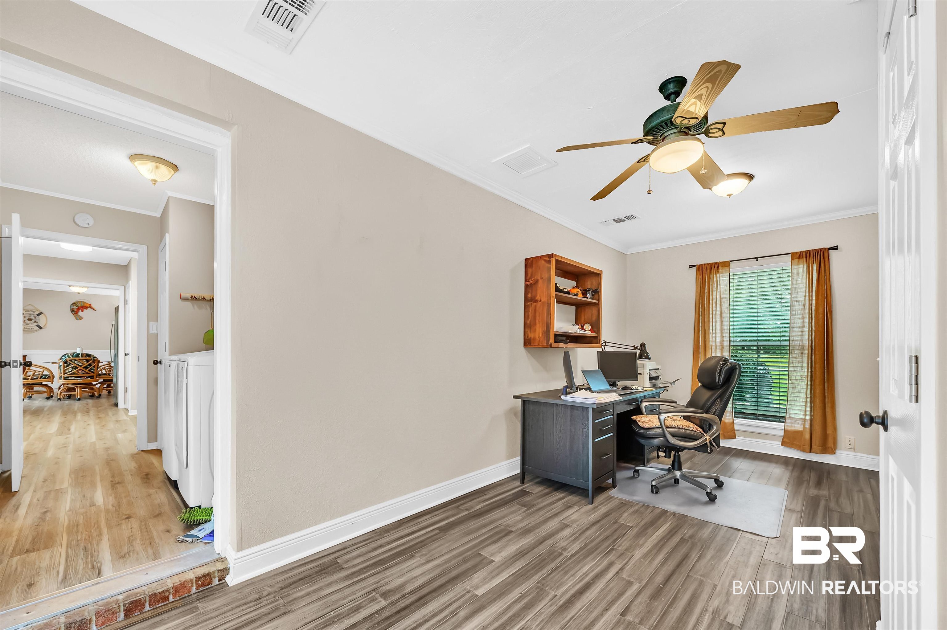 24551 Wolf Bay Drive Foley, AL 36535 - Photo 32 of 59 Office space featuring wood finished floors, ornamental molding, and a ceiling fan