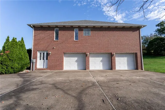 a front view of a house with yard and garage