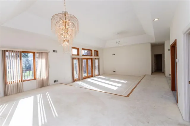 a bedroom with a large bed and a chandelier