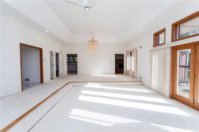 a view of a hall way with entryway and chandelier