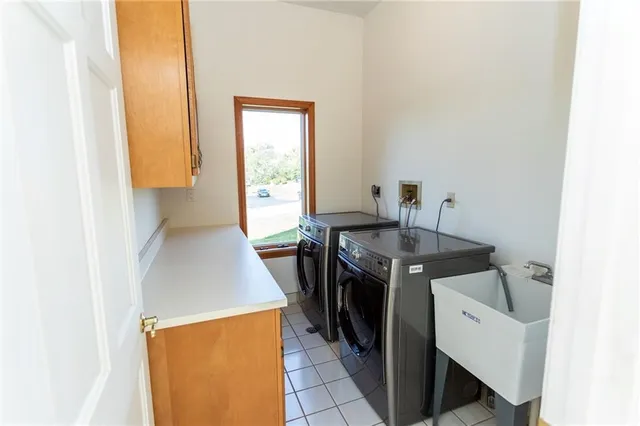 a kitchen with a sink a stove and a microwave