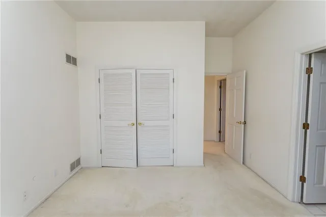 an empty room with closet area