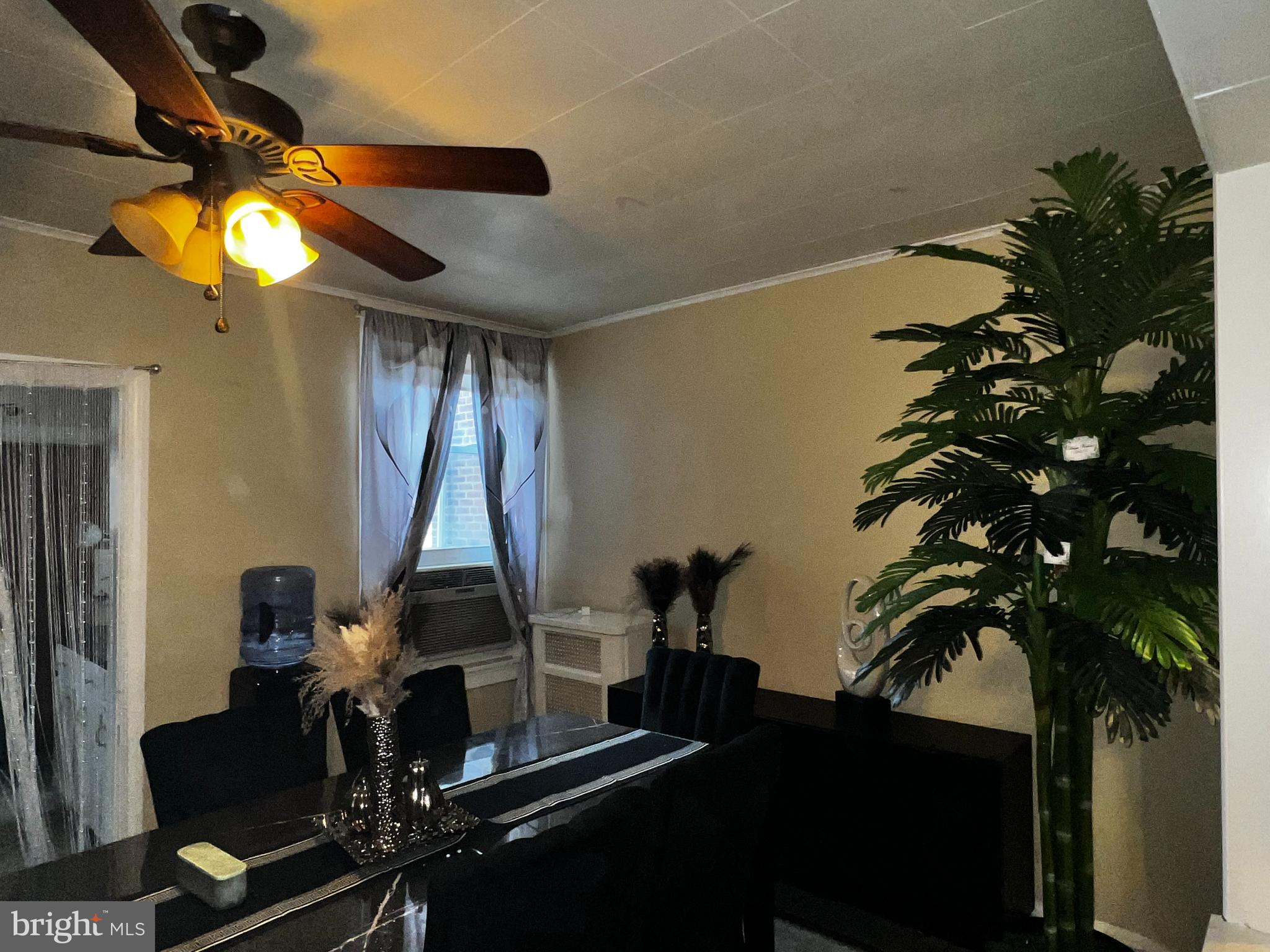 7146 Marsden Street Philadelphia, PA 19135 - Photo 2 of 22 a very nice looking room with a large window and potted plants