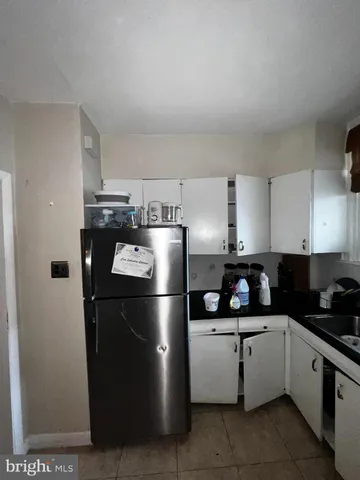 a kitchen with granite countertop a sink a stove and cabinets