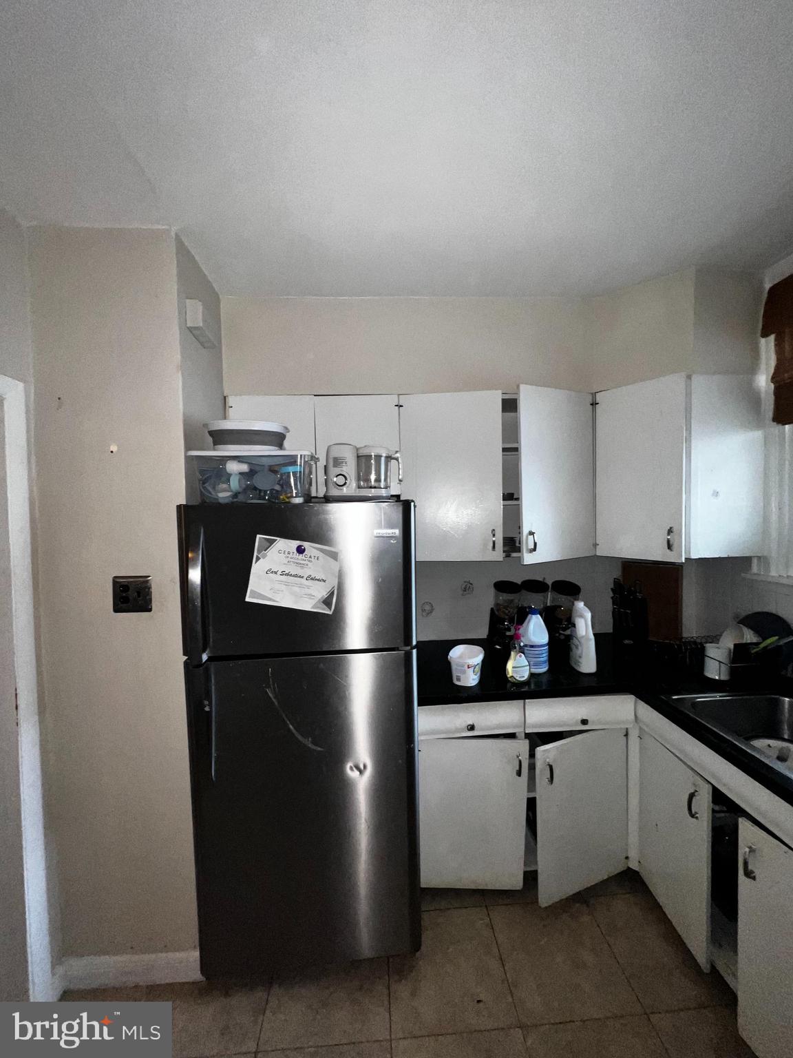 7146 Marsden Street Philadelphia, PA 19135 - Photo 8 of 22 a kitchen with a refrigerator a stove a sink and a stove