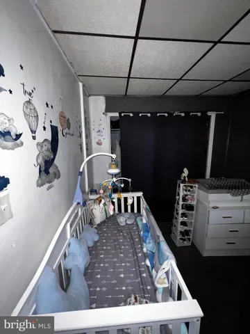 a bedroom with a bed window and a television