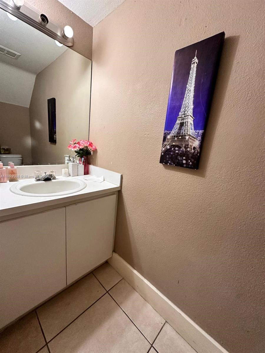 17911 Northwest 68th Avenue, Unit N207 Hialeah, FL 33015 - Photo 11 of 18 a bathroom with a sink and a mirror