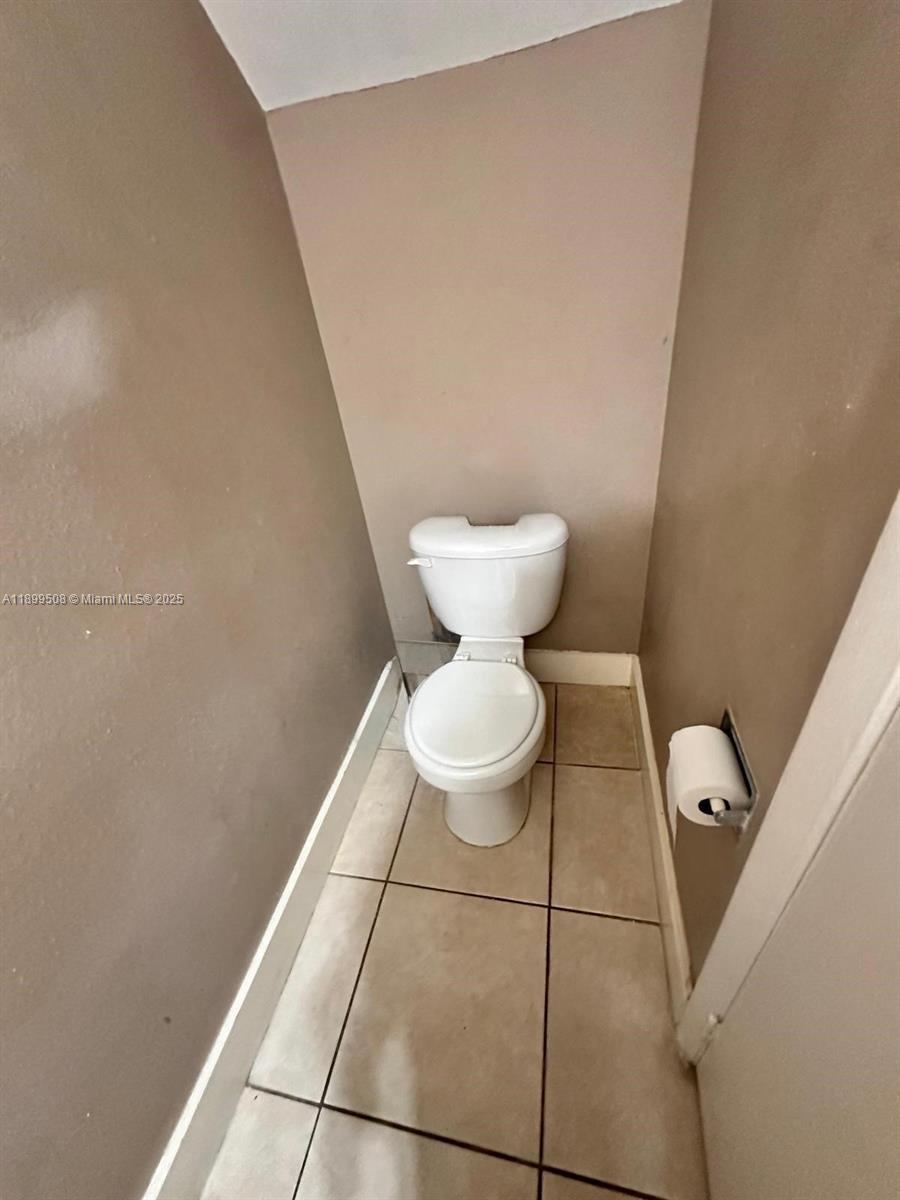 17911 Northwest 68th Avenue, Unit N207 Hialeah, FL 33015 - Photo 12 of 18 a bathroom with a toilet and a mirror