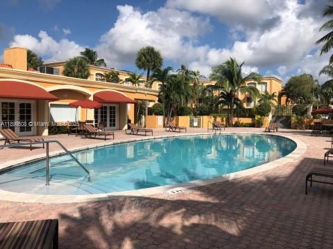 17911 Northwest 68th Avenue, Unit N207 Hialeah, FL 33015 - Photo 2 of 18 an outdoor space with pool and furniture