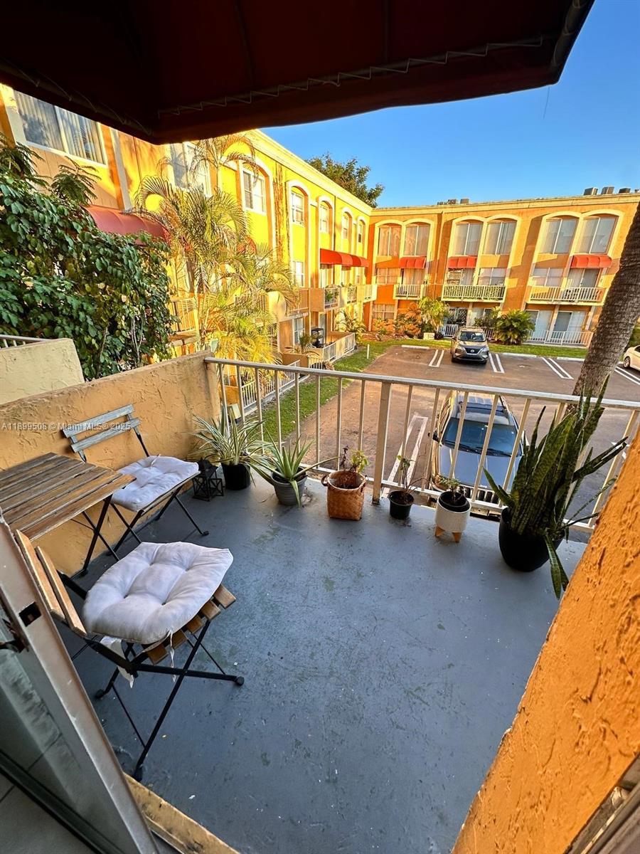 17911 Northwest 68th Avenue, Unit N207 Hialeah, FL 33015 - Photo 5 of 18 a living room with furniture a rug and a floor to ceiling window